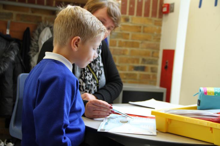 Child reading with an adult